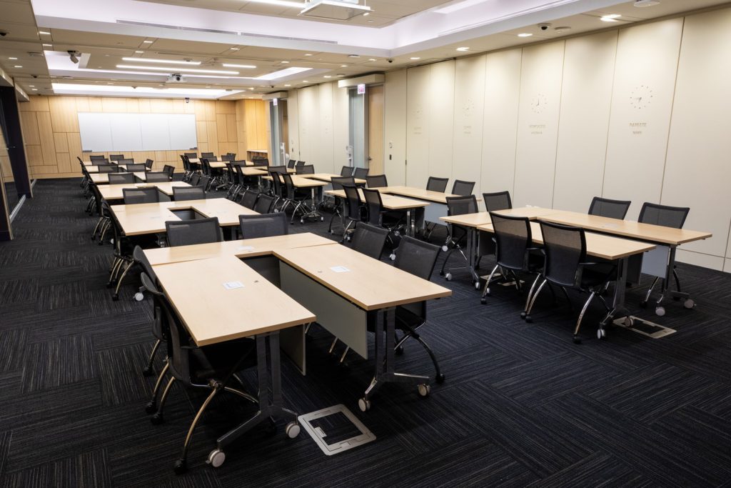 Conference Room 1ABC at One Rotary Place. Photo of a large conference room with tables &amp; chairs and a whiteboard.