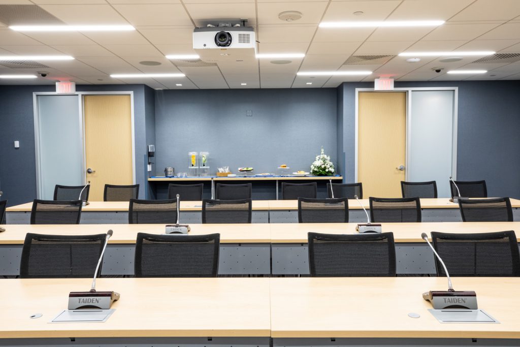 Conference Room 3A at One Rotary Place. Photo of a large conference room with tables &amp; chairs, and catering service food.