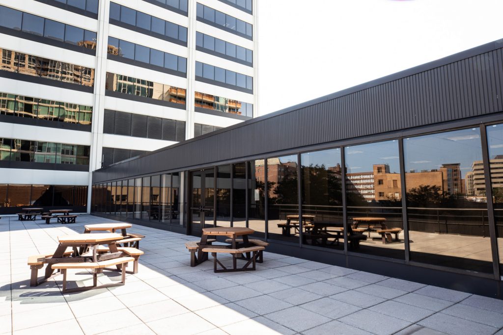 3rd Floor Patio at One Rotary Place. Photo of tables on a large outdoor balcony that can be rented for events and receptions.